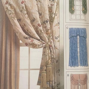 May include: A Vogue Decor V8011 sewing pattern envelope for window treatments. The front displays a beige curtain with a floral pattern and gold tassels, alongside illustrations labelled B, C, and D showing various curtain styles and colours.