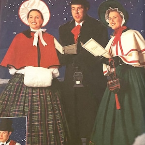 May include: A Simplicity Holiday pattern collection envelope featuring illustrations of three people in Victorian-style winter clothing, including capes, top hats, and bonnets, with a dark blue starry background and text including 8910.