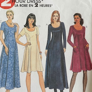 May include: A McCall's 9456 sewing pattern envelope for a 2 Hour Dress. The white paper cover features illustrations of four dress variations labeled A, B, C, and D, showcasing different sleeve lengths, colors, and patterns, including a blue floral print.