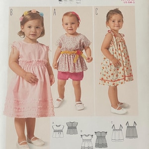 May include: A Burda Kids sewing pattern for children's shirts and dresses. The pattern includes three dress designs, with illustrations of the finished garments. Sizes range from 6 months to 3 years, or EUR 68-98.