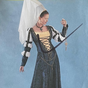 Puede incluir: Un patrón de costura de McCall's Costumes para un vestido de estilo renacentista. El patrón es para la talla EE (14-10-10-20) y se llama "4041". El patrón muestra a una mujer con un vestido largo azul oscuro con un corpiño blanco con cordones y un tocado blanco. El vestido tiene mangas largas con puños blancos y un cinturón de cadena dorada.