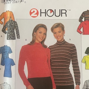 May include: A Simplicity sewing pattern envelope, number 7642, for mock turtleneck tops in sizes 18, 20, and 22. The white paper envelope features illustrations of various long and short-sleeve top designs in solid colors, stripes, and animal prints.