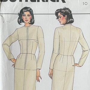 May include: A vintage sewing pattern for a dress, featuring a front and back view of a woman wearing a beige dress with a zipper down the front. The pattern is for size 10 and is from Butterick.