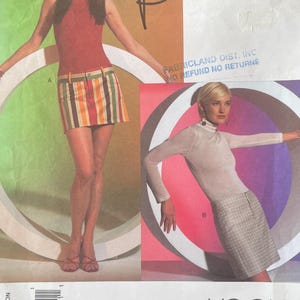 May include: Vogue pattern V2811 by Alice + Olivia. The image shows a woman in a red turtleneck and striped mini skirt, and another in a sheer turtleneck and plaid skirt. The pattern size is 6, 8, and 10. The Vogue logo is visible.