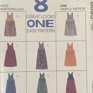 May include: A McCall's 8395 sewing pattern envelope featuring eight variations of a pinafore dress. The white paper cover displays illustrations of different dress styles labelled A through H, with the text 8 GREAT LOOKS ONE EASY PATTERN.