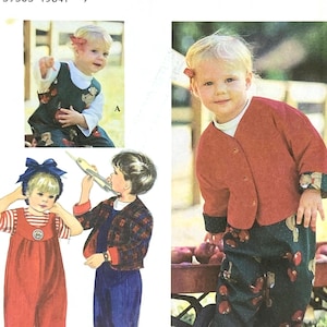 May include: Simplicity sewing pattern featuring children's clothing designs. The pattern includes illustrations of a child wearing a red jacket and green pants with apple and teddy bear motifs. The pattern number is 9138, size A 1,2,3,4.