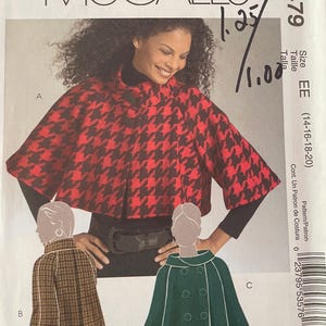 May include: A McCall's M5479 sewing pattern envelope for a cape in sizes EE (14-16-18-20). The cover features a photograph of a red and black houndstooth cape and illustrations of a brown plaid cape and a solid green double-breasted cape.