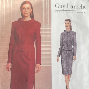 May include: A vintage Vogue sewing pattern for a Guy Laroche design. The pattern features a two-piece suit with a long-sleeved jacket and a knee-length skirt. The cover shows a woman wearing the suit in a reddish-brown fabric.
