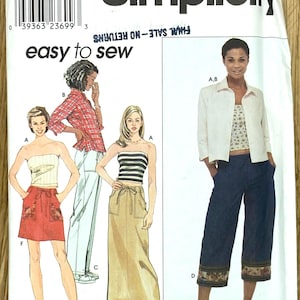May include: Simplicity sewing pattern 9053 showing women's clothing designs. The pattern includes options for a tube top, skirt, trousers, and jacket. The pattern size is RR 14, 16, 18, and 20.