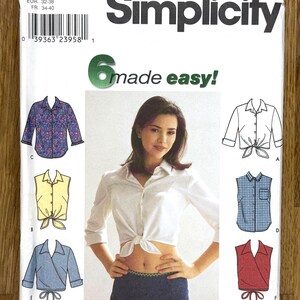 May include: Simplicity sewing pattern featuring six shirt designs. The pattern includes sizes 6, 8, 10, and 12. The image shows a woman wearing a white shirt tied at the waist, with illustrations of other shirt styles.