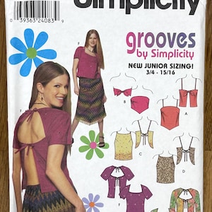 May include: Simplicity sewing pattern with a woman modelling a top and skirt. The pattern includes different top designs with bows and open backs. The text on the pattern reads "grooves by Simplicity" and "easy to sew".