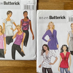 May include: Two Butterick sewing pattern envelopes. The B5608 envelope features illustrations of tops in white, pink, and purple. The B5495 envelope shows tops in purple, gray, red, and white with black polka dots. Both envelopes display the size range FF (16-18-20-22).