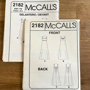 May include: Two McCall's sewing pattern envelopes. The front of the pattern shows illustrations of a sleeveless dress. The text on the pattern includes "2182", "FRONT", "BACK", and "DELANTERO / DEVANT".