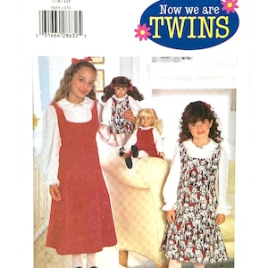 May include: A Butterick sewing pattern package with the text "Now we are TWINS". The package features two young girls wearing matching dresses, one solid red and the other with a dalmatian print. The package also shows two dolls wearing matching outfits.