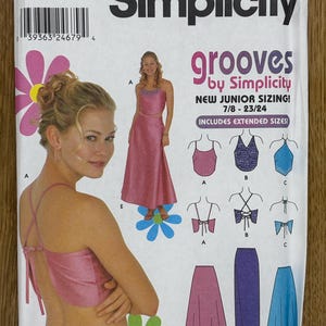 May include: Simplicity pattern 9587 for a sleeveless dress with a halter top and a skirt. The pattern includes sizes 7/8 to 23/24 and is for junior sizing. The pattern is for a pink dress with a blue floral print.