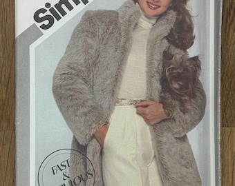 May include: Simplicity sewing pattern 5225 featuring a woman in a faux fur coat and white pants. The pattern includes sizes N (10, 12, & 14). The text "Fast & Fabulous" is in a circle on the pattern.