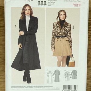 以下が含まれることがあります： Burda Styleのコートとジャケットの型紙封筒6845。表面には2種類の衣類バリエーションが示されています。Aとラベル付けされた長い黒のコートと、Bとラベル付けされたヒョウ柄のジャケットとベージュのスカートです。技術的な線画が含まれています。
