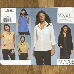 May include: Vogue Basic Design sewing pattern 2634. The pattern features multiple shirt styles, including a sleeveless top, short-sleeved shirt, and long-sleeved shirt. The pattern includes sizes 12, 14, and 16. The cover shows images of the finished garments.