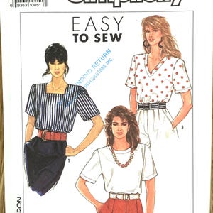 May include: Simplicity sewing pattern U5 (sizes 16-24), featuring illustrations of three different women's tops and skirts. The pattern includes the text "Easy to Sew" and the Simplicity logo.