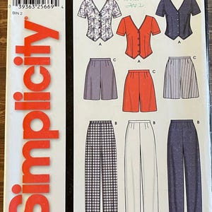 May include: Simplicity sewing pattern 7154, with tops and bottoms. Includes a floral print top, red button-up top, and a navy blue top. Bottoms include shorts and trousers in various colors and patterns. Size A 8-18, EUR 34-44, FR 36-46.