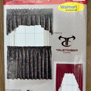 May include: A window treatment set package featuring a camouflage pattern valance and curtain panel. The package includes the text "IT'S SO EASY" and "Walmart Exclusive!"