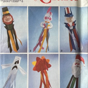 May include: A Simplicity Crafts pattern for making six different windsocks. The windsocks feature a leprechaun, a bunny rabbit, Uncle Sam, a ghost, a flower, and Santa Claus. The pattern is for one size.
