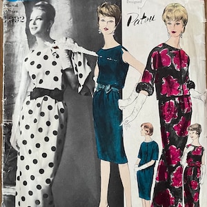 May include: Vintage Vogue Paris Original sewing pattern designed by Patou. The pattern is for a dress with a polka dot print and a dress with a floral print. The pattern number is 1092.