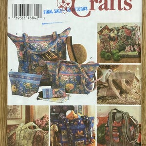May include: A Simplicity Crafts sewing pattern with multiple bag designs. The bags display floral and patchwork patterns in blue, pink, and green. The pattern includes tote bags, a cosmetic bag, and a duffel bag. The text "FINAL SALE NO RETURNS" is visible.