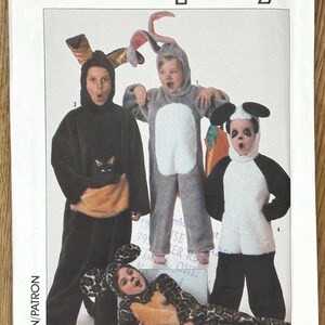 May include: A Simplicity pattern envelope featuring children in animal costumes: a cat, a rabbit, a panda, and a leopard. The costumes are black, gray, white, and tan. The size range is 2-4.