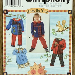 May include: Simplicity sewing pattern 7277 for children's clothing. The pattern includes options for a blue and red outfit with floral and plaid accents, a blue dress, and a red and black outfit. The text "Just Be 'Cuz" is also visible.