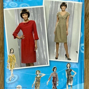 May include: Simplicity sewing pattern 2550 with Project Runway designs. The pattern shows images of dresses in red, green, and black. The pattern size is D5 4,6,8,10,12. The text "Sign-up for our free newsletter today at simplicity.com" is also visible.