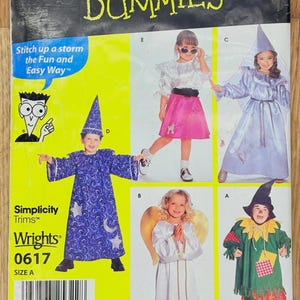 May include: A vintage Simplicity sewing pattern for children's costumes. The pattern features various costume designs, including a wizard, angel, and scarecrow. The packaging is yellow and has the text "Sewing Patterns for Dummies".