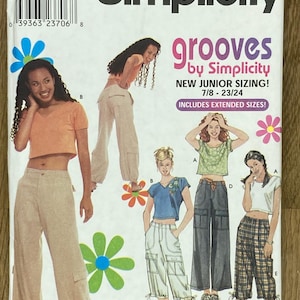 May include: Simplicity sewing pattern for the "grooves" collection, showcasing junior-sized outfits. The pattern includes illustrations of crop tops and cargo pants. The pattern size range is 7/8-23/24.