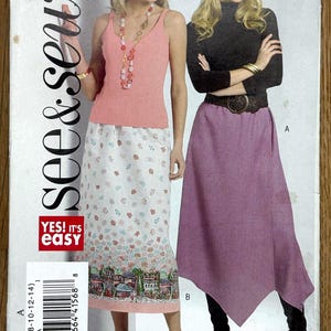 May include: A sewing pattern titled "See & Sew" B5014. The pattern features two women modeling different skirt and top combinations. One woman wears a pink tank top and a floral skirt, the other a black turtleneck and a purple skirt.