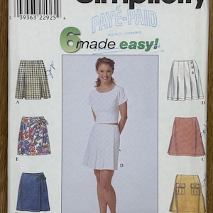 May include: A sewing pattern for a skirt, Simplicity pattern number 8680, size P, for sizes 12, 14, and 16. The pattern includes five different skirt styles: a plaid skirt, a floral wrap skirt, a denim wrap skirt, a white pleated skirt, and a yellow skirt with pockets. The pattern is labeled "Paye-Paid" and "Made Easy!"