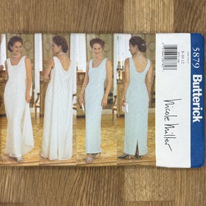 May include: A sewing pattern for a long, sleeveless dress with a scoop neck. The pattern is by Butterick and is for size 8-10-12. The pattern is for a dress with a back slit and a fitted bodice.