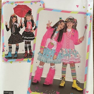 May include: Simplicity sewing pattern number 2522 for girls' clothing, sizes 7-14. The pattern includes three different outfits: a black and white polka dot dress with a black vest, a black and white striped dress with a black vest, and a pink and blue dress with a pink cardigan. The pattern also includes instructions for making a belt, a headband, and a pair of leg warmers.