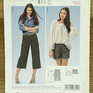May include: A Burda Young 6600 sewing pattern envelope for pants and shorts. The front displays two styles: A, olive green cropped cargo pants, and B, plaid shorts. Includes size range EUR 32-44 and US 6-18, with technical line drawings of both designs.