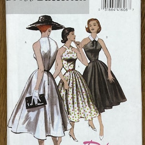May include: Butterick B5033 sewing pattern with illustrations of three retro dresses. The cover shows a white dress, a polka-dot dress, and a black dress. The text "Retro Butterick '52" is displayed. The pattern size is EE (14-16-18-20).