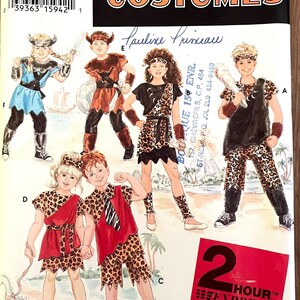 May include: Simplicity Costumes pattern featuring children's costumes. Designs include a Viking, a gladiator, and a cave dweller. The costumes are in various colors, including blue, red, and brown, with leopard print accents. The pattern includes sizes S, M, and L.