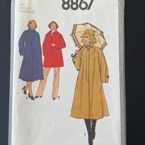 May include: Simplicity 8867 sewing pattern. The pattern shows illustrations of three women wearing coats in blue, red, and tan. The pattern includes the text "PATTERN/PATRON Simplicity 8867" and "20% HALF-SIZE DEMI-TAILLE".