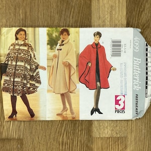 May include: A Butterick sewing pattern envelope featuring three cape designs. The capes are shown in various colors and patterns, including a patterned brown and white cape, a beige cape, and a red cape. The envelope reads "4099 Butterick FAST&EASY".