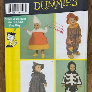 May include: A sewing pattern for toddlers' costumes. The pattern includes four costumes: a scarecrow, a witch, a skeleton, and a candy corn. The pattern is from the "Sewing for Dummies" series. The pattern number is 4908.