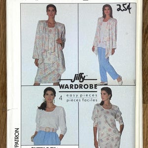May include: A vintage Simplicity sewing pattern for a 'Jiffy Wardrobe', with four easy pieces. The pattern shows a woman in different outfits, such as a jacket, top, skirt, and dress. The pattern number is 9022. Includes text in English and French.