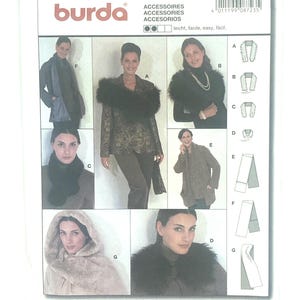 May include: A Burda sewing pattern packet showcasing accessory designs. The packet displays images of scarves, collars, and a hooded cape. Text on the packet reads "ACCESSOIRES ACCESSORIES ACCESORIOS" and "ALL PATTERNS WITH SEAM AND HEM ALLOWANCES".