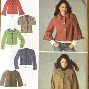 May include: Simplicity sewing pattern with jacket designs. The pattern includes options for a red jacket with flared sleeves, a green jacket, a grey jacket, and a brown jacket. The pattern also includes sizing information.