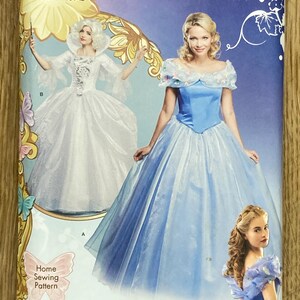 May include: Simplicity sewing pattern for a Cinderella costume. The package features images of Cinderella in a blue ball gown and another woman in a white gown. The pattern includes sizes U.S. 6-14.