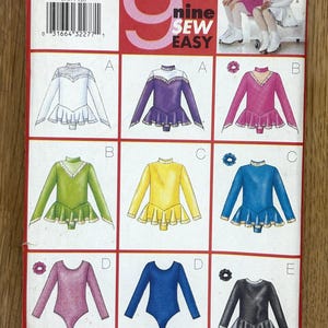 May include: A vintage Butterick sewing pattern, size 12-14, showcasing nine easy figure skating dress designs. The pattern includes illustrations of dresses in various colours, including white, purple, pink, green, yellow, and blue. The text "nine SEW EASY" is visible.