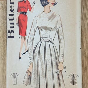 May include: Vintage Butterick sewing pattern for young junior and teen dresses. The pattern features illustrations of two dresses, one red and one white, with a variety of design details. Sizes 9-16 are included.