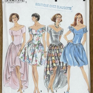 May include: Simplicity dressmaking pattern showing four off-the-shoulder dresses in pink, floral, silver, and blue. The pattern includes the text "BOUTIQUE CHEZ CLAUDETTE" and the number "8354".